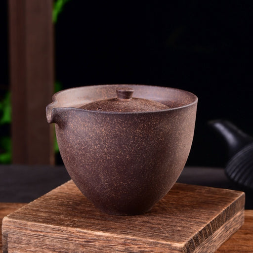 Ceramic pot with lid on a wooden stand against a dark background